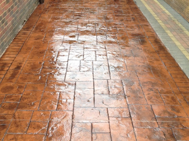 New concrete driveway in Stretford in a Terracotta stone printed in Ashlar cut and sealed in mid sheen