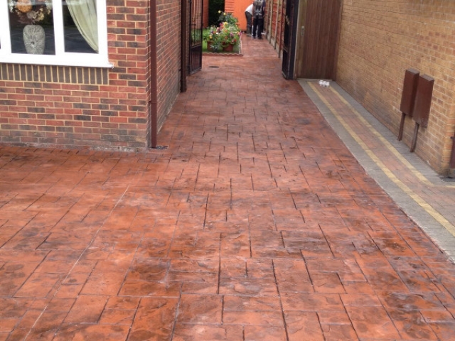 New concrete driveway in Stretford in a Terracotta stone printed in Ashlar cut and sealed in mid sheen