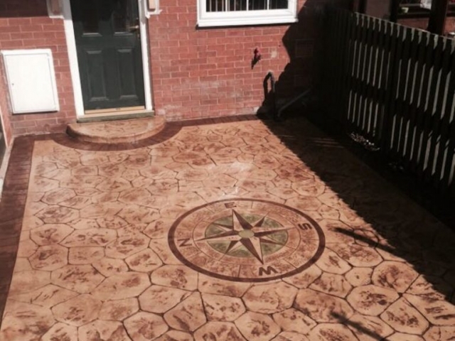 Sandstone walnut colour with acid edge printed concrete driveway